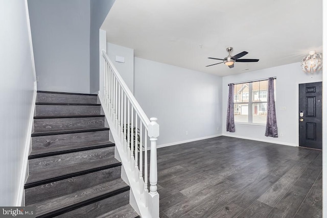 stairs with a ceiling fan, wood finished floors, and baseboards