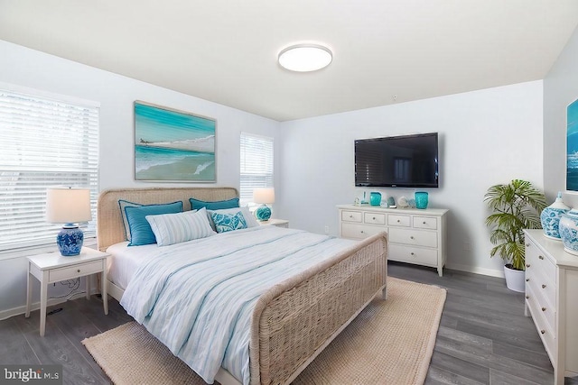 bedroom with wood finished floors and baseboards