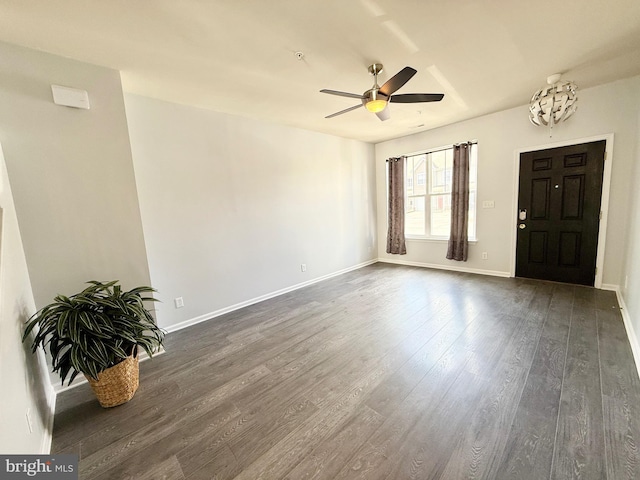 entryway with baseboards, dark wood-type flooring, and a ceiling fan