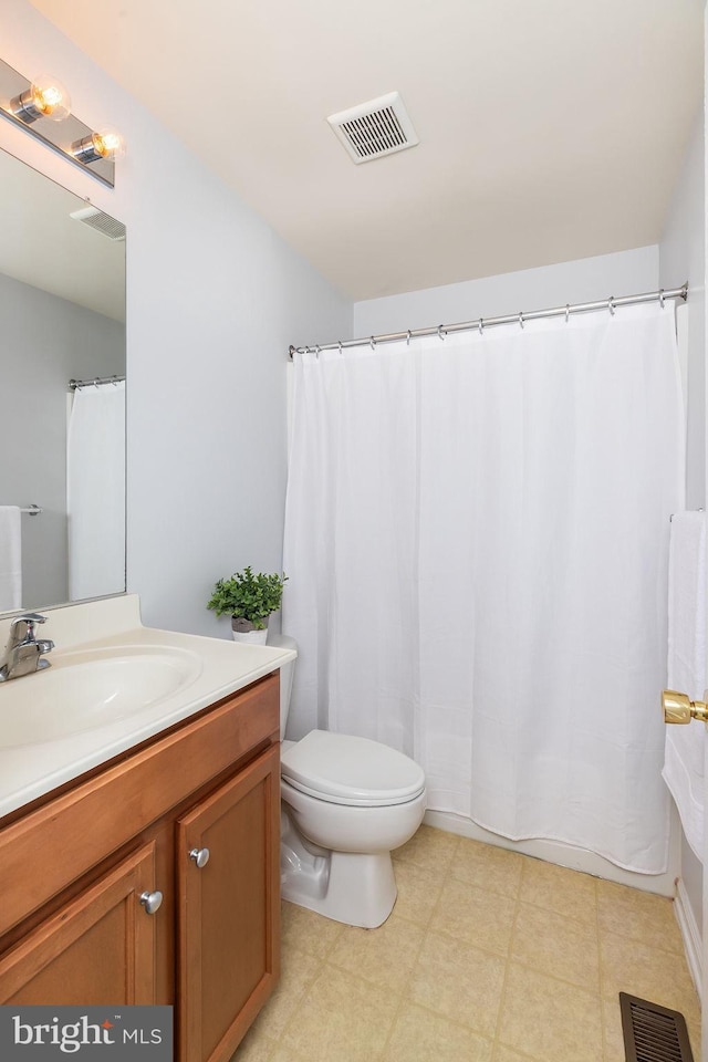 bathroom with tile patterned floors, visible vents, toilet, and vanity