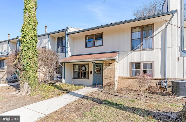 view of front of house featuring brick siding and central AC unit