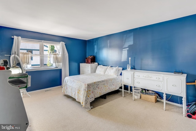 bedroom featuring baseboards, visible vents, and carpet flooring