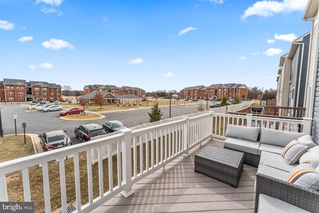 wooden terrace featuring a residential view and an outdoor hangout area