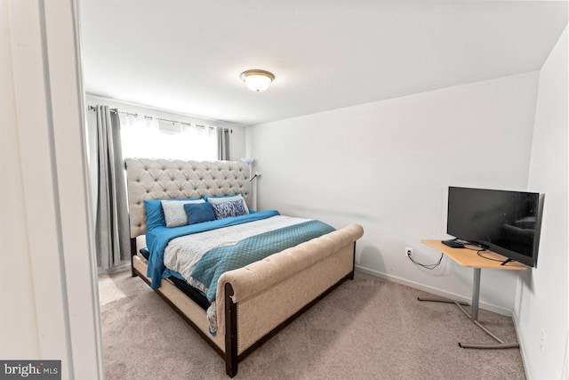 bedroom featuring carpet floors and baseboards