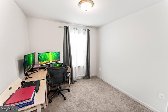 carpeted home office with baseboards