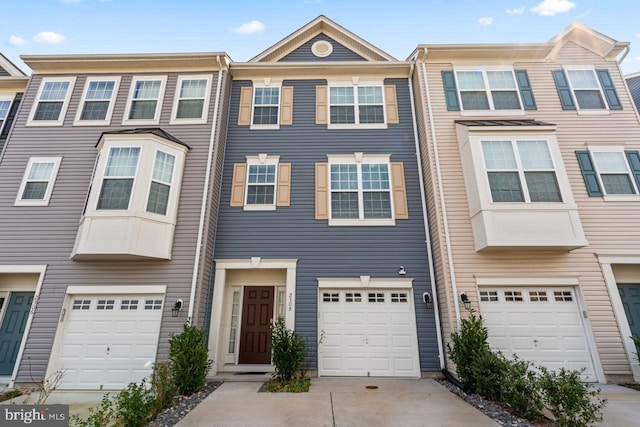 multi unit property featuring a garage and driveway