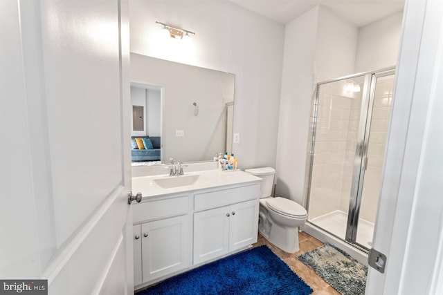 full bath with toilet, tile patterned floors, a shower stall, and vanity