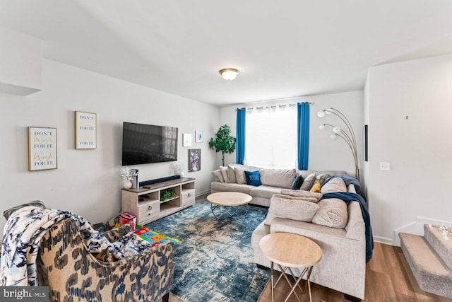 living room with baseboards and wood finished floors