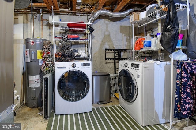 washroom with laundry area, independent washer and dryer, and electric water heater