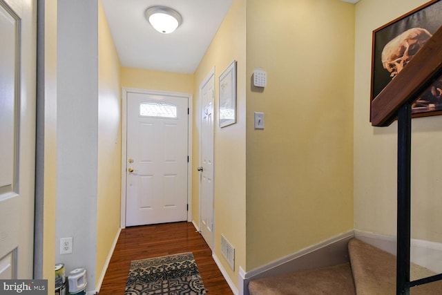 entryway with visible vents, baseboards, and dark wood-style floors