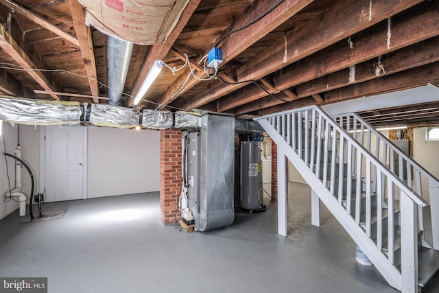 unfinished basement featuring heating unit, stairway, and electric water heater