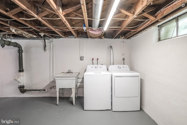 clothes washing area featuring laundry area and washer and clothes dryer