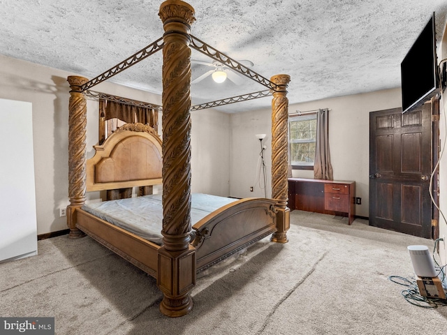 bedroom with baseboards, ceiling fan, a textured ceiling, and carpet