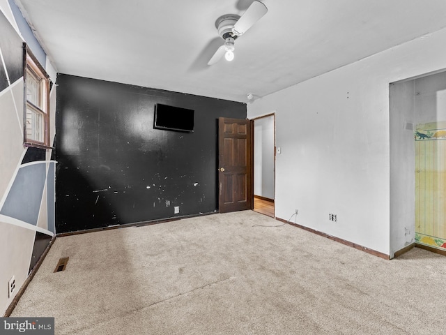 unfurnished bedroom featuring visible vents, baseboards, carpet, and ceiling fan