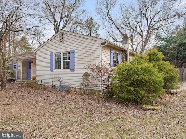 view of front of house featuring fence and a chimney