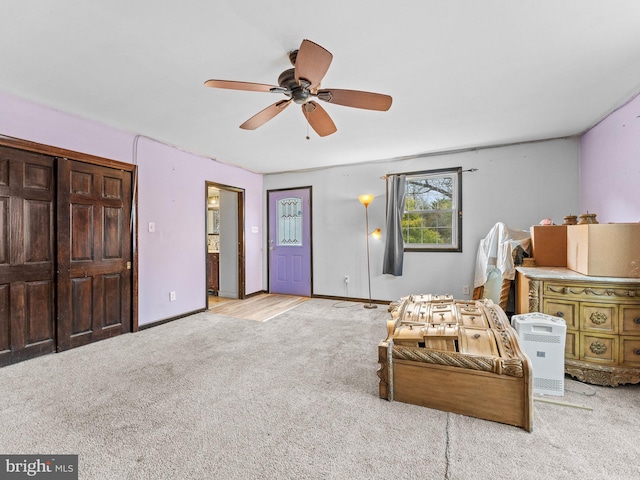 sitting room featuring baseboards, ceiling fan, and carpet floors