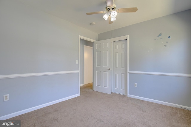 unfurnished bedroom with a closet, ceiling fan, baseboards, and carpet floors