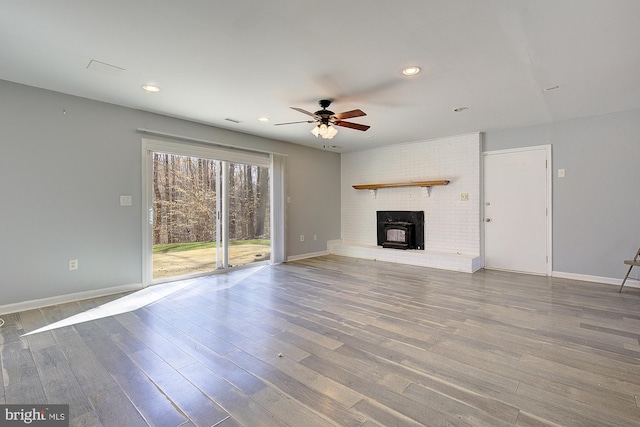 unfurnished living room featuring recessed lighting, baseboards, and wood finished floors