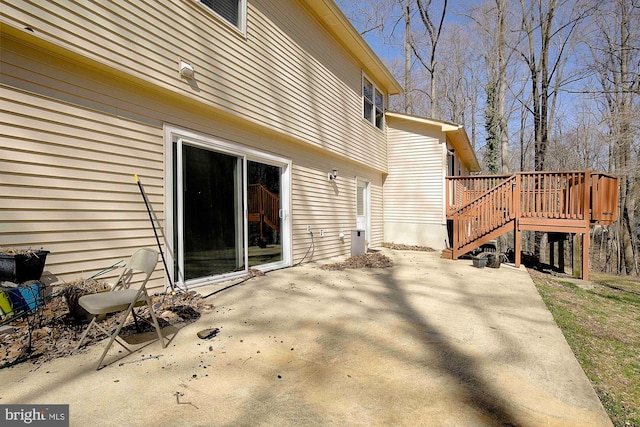 exterior space with a deck, stairs, and a patio