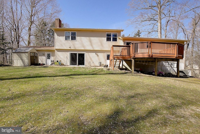 back of property with a shed, a lawn, a chimney, an outdoor structure, and a deck