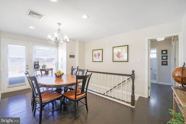 dining room featuring a healthy amount of sunlight, visible vents, baseboards, and dark wood-style flooring