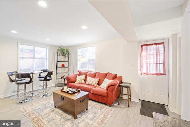 living room with recessed lighting, plenty of natural light, and light wood-style floors