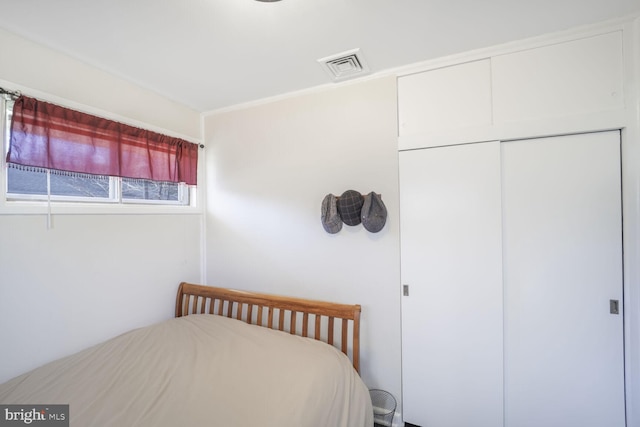 bedroom featuring visible vents and a closet