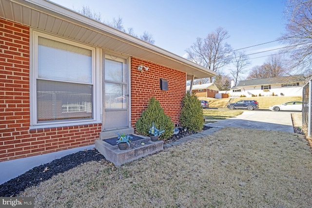 doorway to property with brick siding