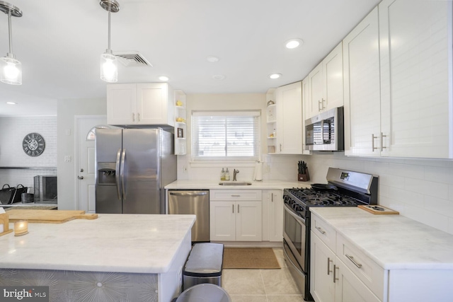 kitchen with open shelves, visible vents, appliances with stainless steel finishes, white cabinets, and a sink