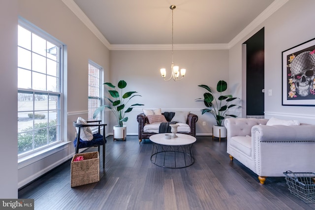 living room featuring baseboards, an inviting chandelier, wood finished floors, and crown molding