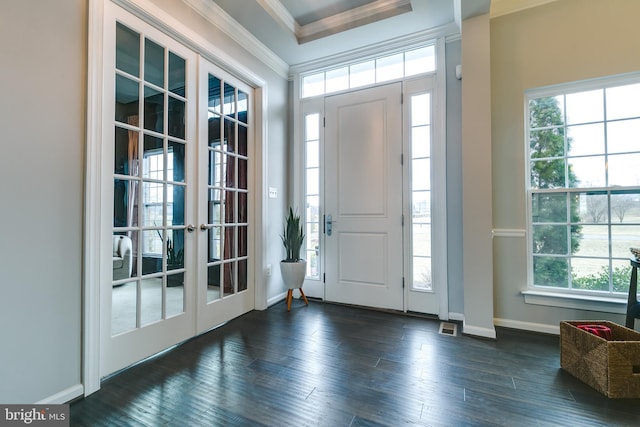 entrance foyer with french doors, baseboards, dark wood-type flooring, and crown molding