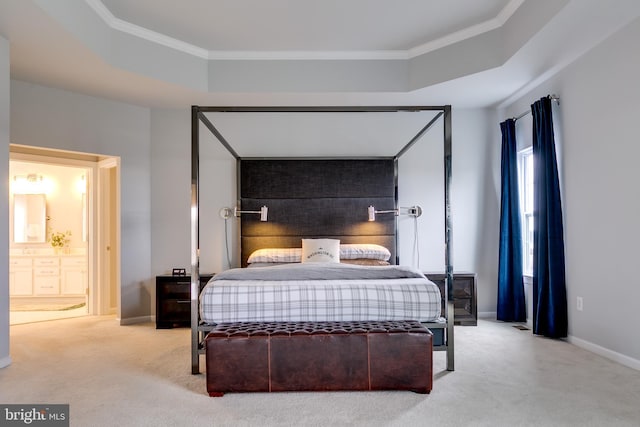 carpeted bedroom featuring ensuite bathroom, crown molding, and baseboards