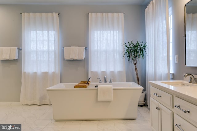 full bathroom with a soaking tub, marble finish floor, vanity, and toilet