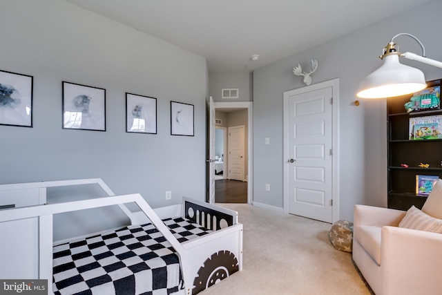 carpeted bedroom featuring visible vents