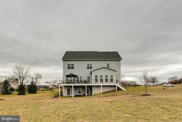 back of property featuring stairway, a wooden deck, and a yard