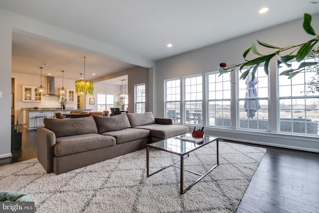 living room featuring recessed lighting and dark wood-style floors