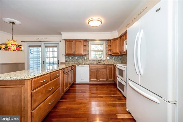 kitchen featuring brown cabinets, white appliances, and open shelves