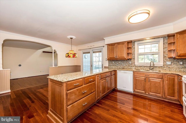 kitchen featuring brown cabinetry, open shelves, a peninsula, a sink, and dishwasher