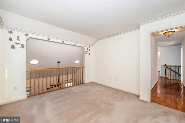 carpeted empty room with baseboards