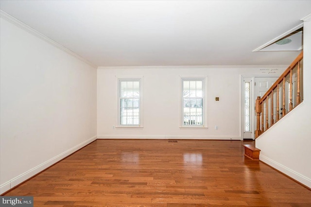 entryway featuring stairs, crown molding, baseboards, and wood finished floors