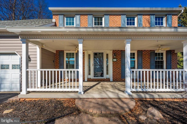 view of front facade featuring brick siding, covered porch, and a garage