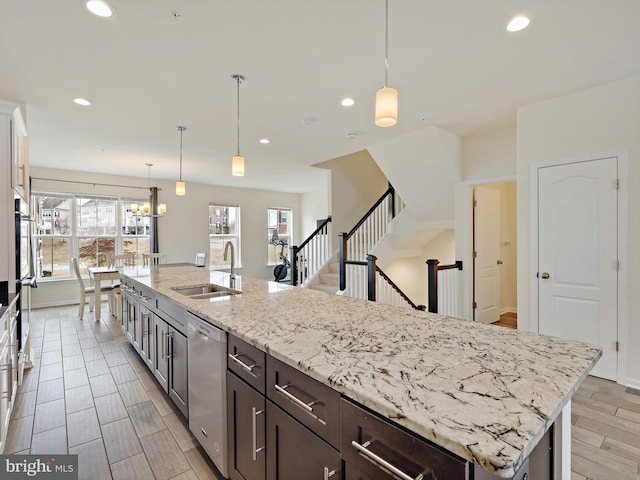 kitchen featuring recessed lighting, a sink, wood tiled floor, dishwasher, and plenty of natural light