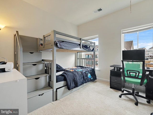 carpeted bedroom with baseboards and visible vents