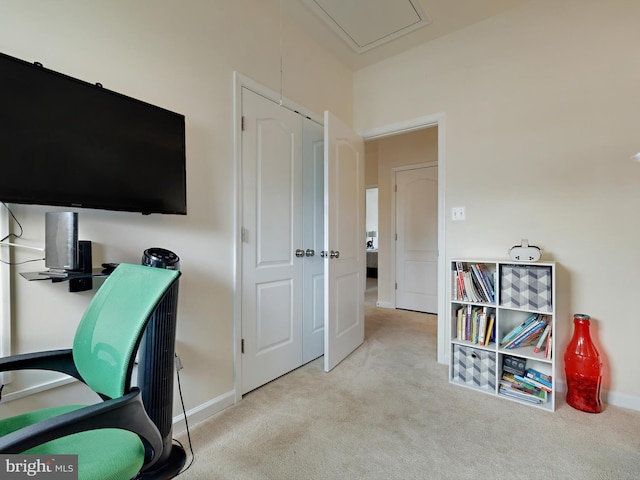 home office featuring attic access, baseboards, and light colored carpet