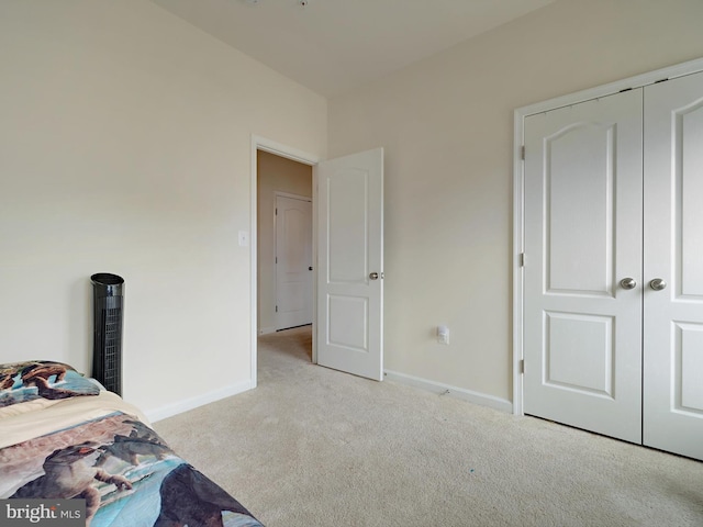 unfurnished bedroom featuring a closet, carpet, and baseboards