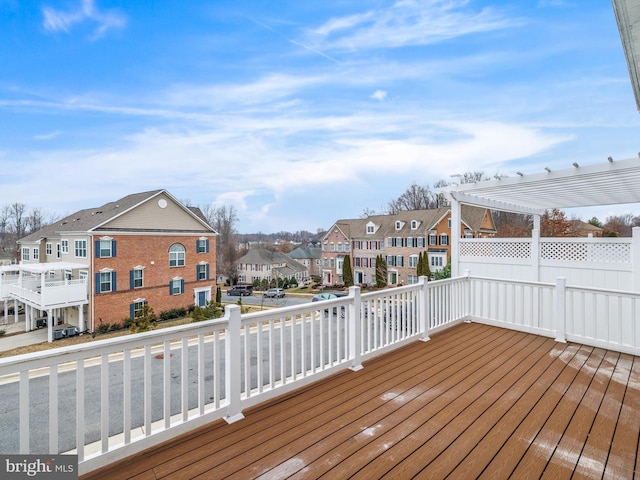 wooden deck with a residential view and a pergola