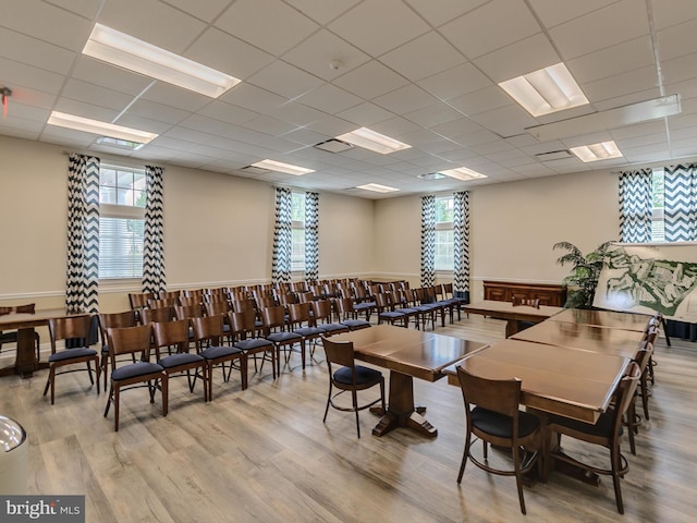 dining room with a paneled ceiling, visible vents, and wood finished floors