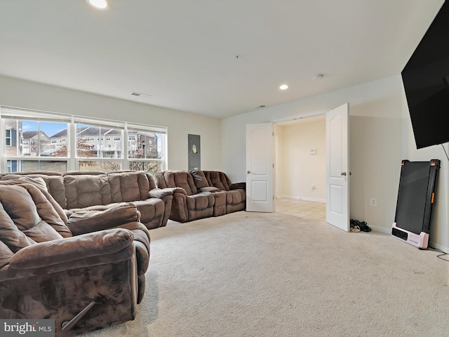 carpeted living area featuring visible vents, baseboards, and recessed lighting