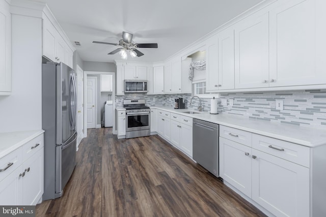 kitchen with white cabinets, tasteful backsplash, stainless steel appliances, and a sink