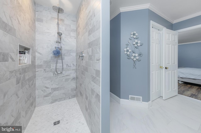 ensuite bathroom with crown molding, visible vents, ensuite bath, tiled shower, and baseboards